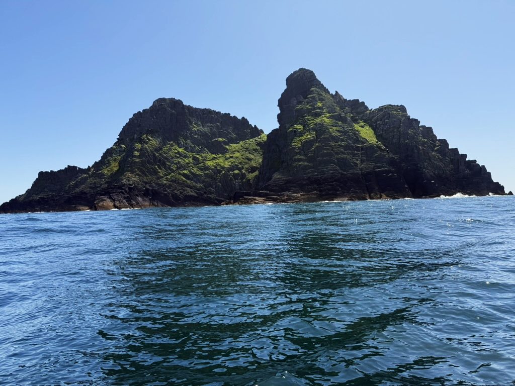 Skellig Michael rising from the sea, seen from a boat