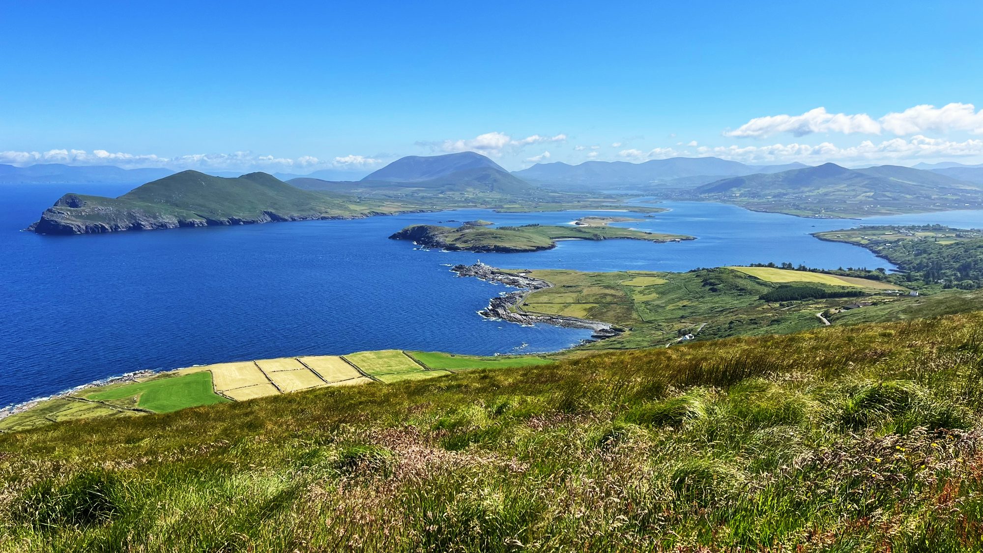View from high ground over the harbour, the lighthouse and the mountains of the mainland